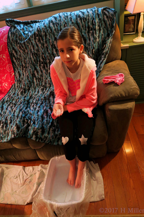 Waiting To Put Salt In Her Kids Pedicure Footbath. Waiting To Put Salt In Her Kids Pedicure Footbath.