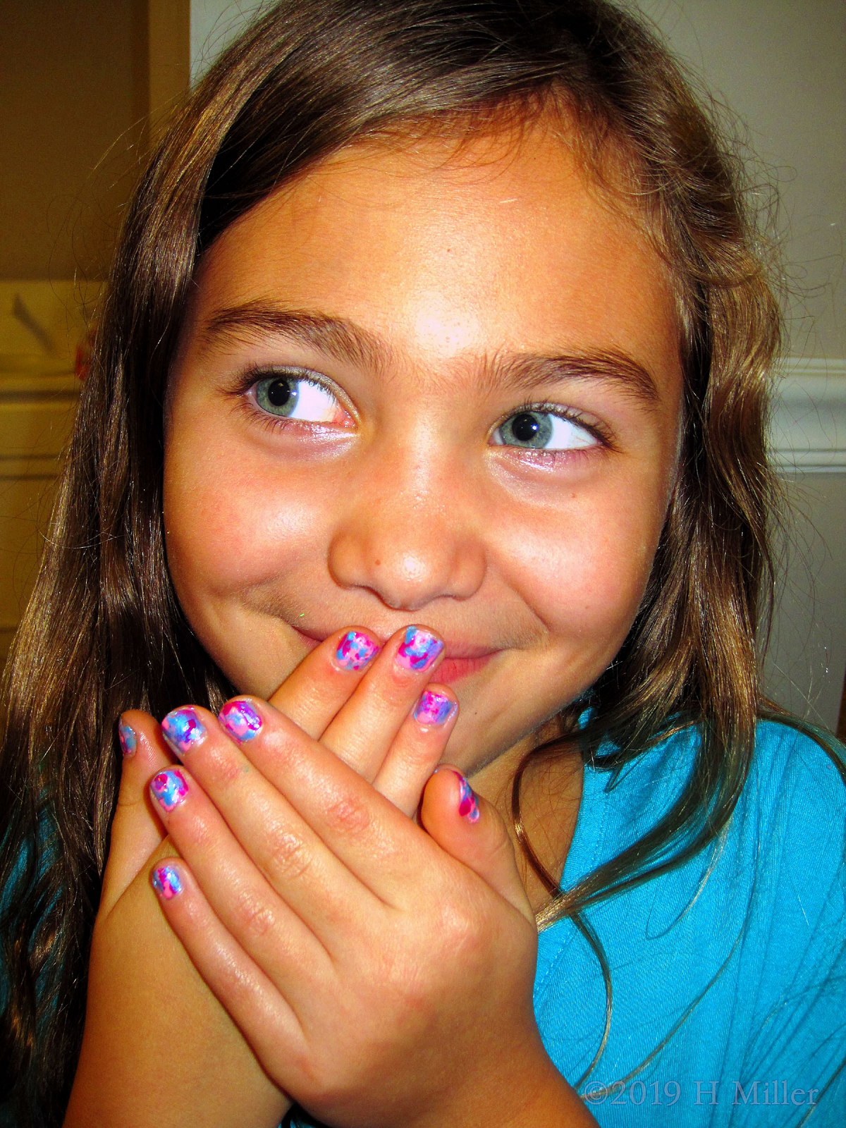 Multicolored Girls Mani Looking To The Side With A Smile