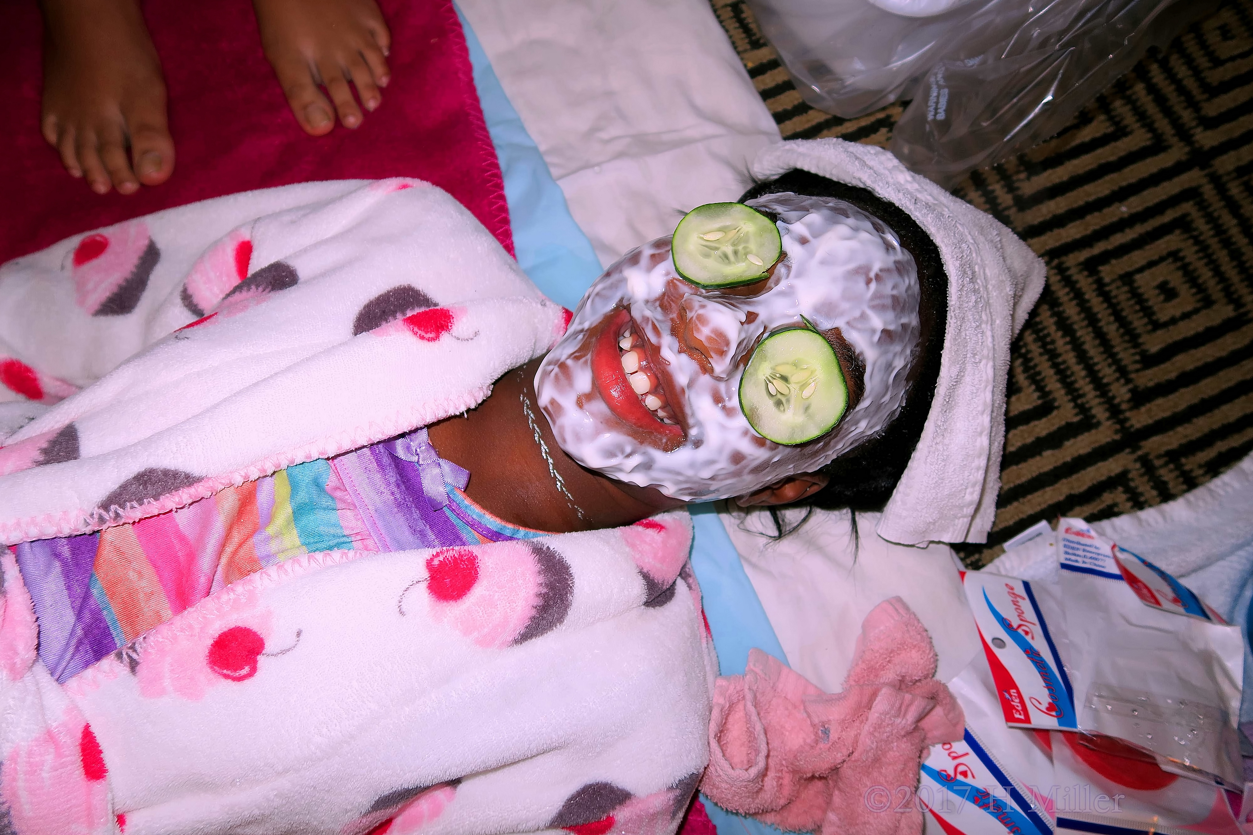Smiling During Kids Facials With Cukes On Her Eyes. Smiling During Kids Facials With Cukes On Her Eyes.