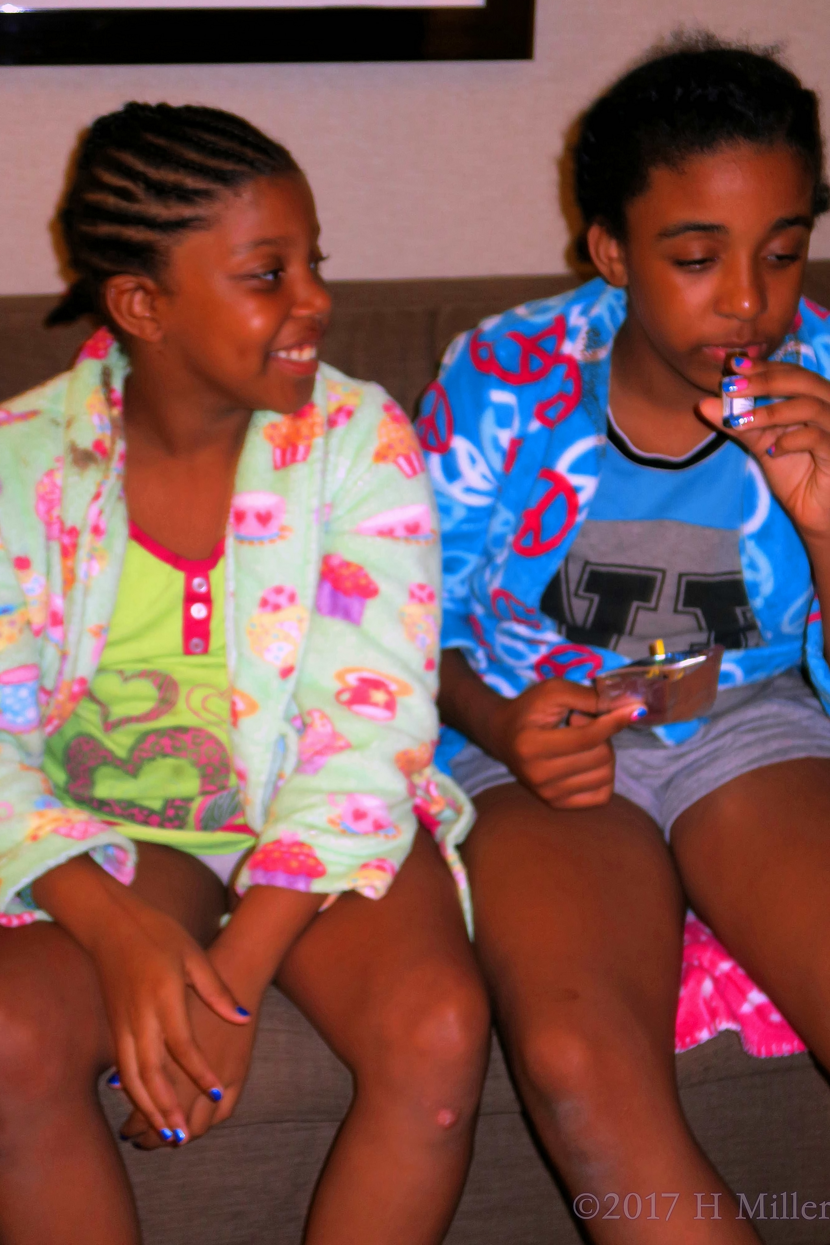 Looking On As Her Friend Smells The Essential Oil. Looking On As Her Friend Smells The Essential Oil.
