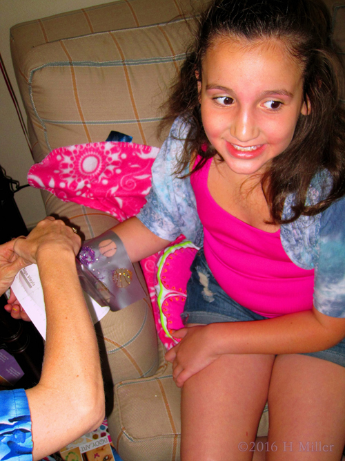 Getting Her Cool Glittery Temporary Tattoo. Getting Her Cool Glittery Temporary Tattoo.