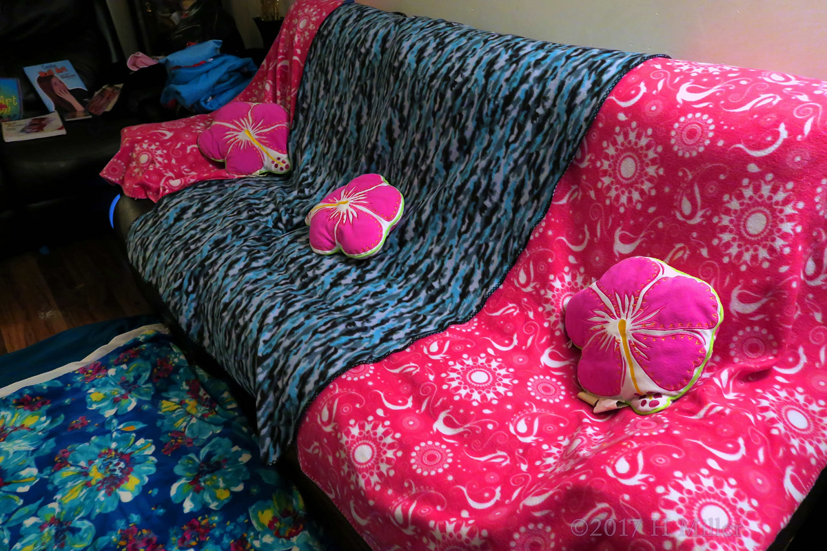 Comfy Kids Spa Couch Decorated With Colorful Throws And Cushions.