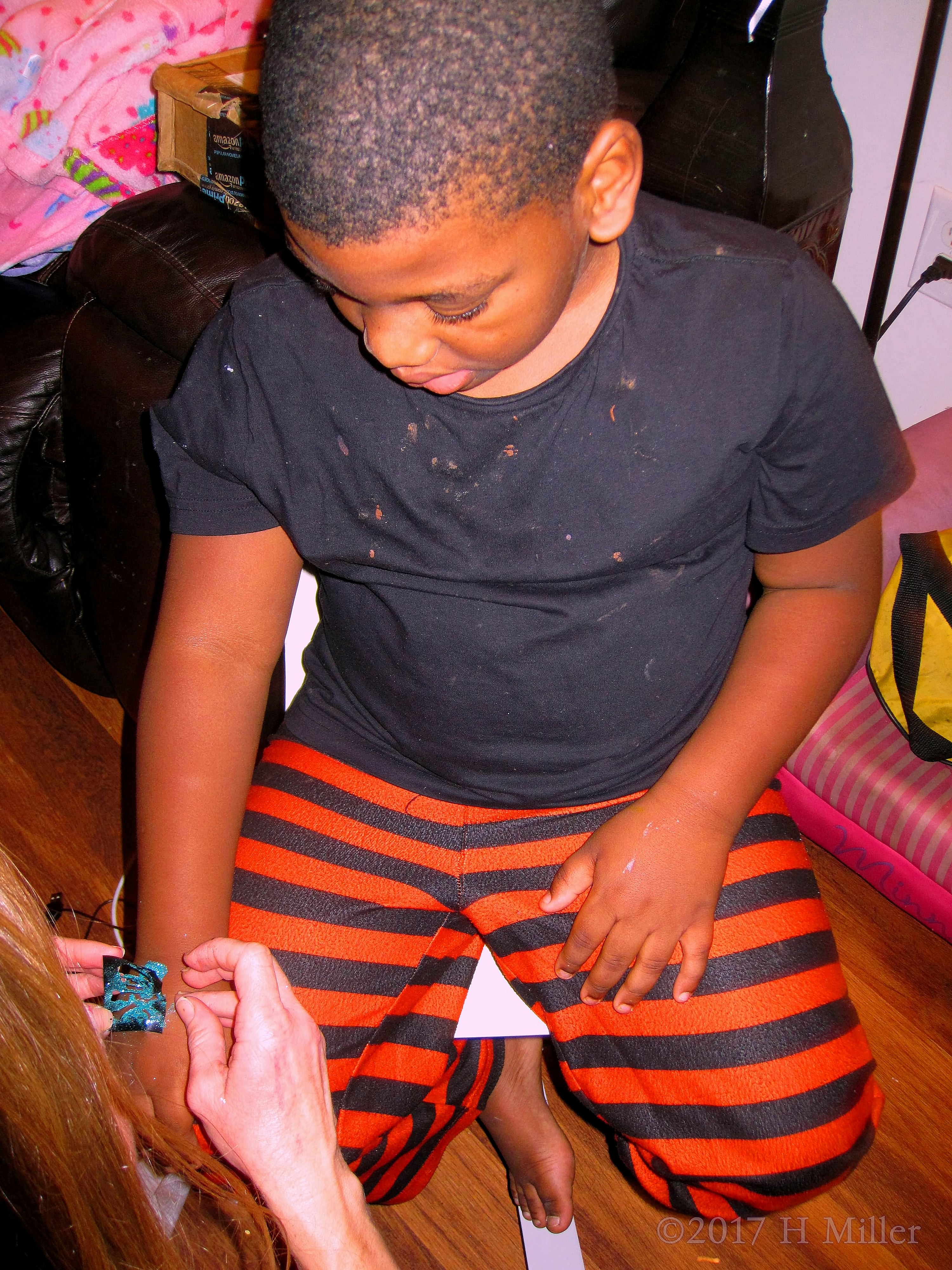 While Getting A Temporary Glitter Tattoo, He Looks On At The Design Process. While Getting A Temporary Glitter Tattoo, He Looks On At The Design Process.