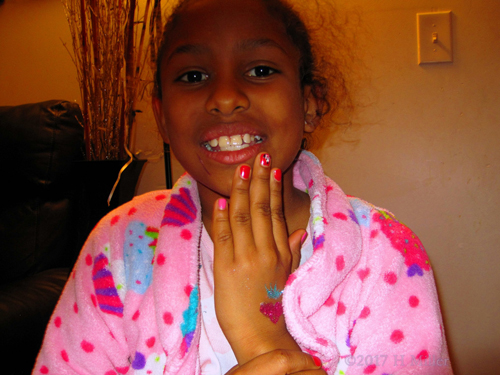 Smiling After Her Pretty Girls Mani And Glittery Temporary Tattoo. Smiling After Her Pretty Girls Mani And Glittery Temporary Tattoo.