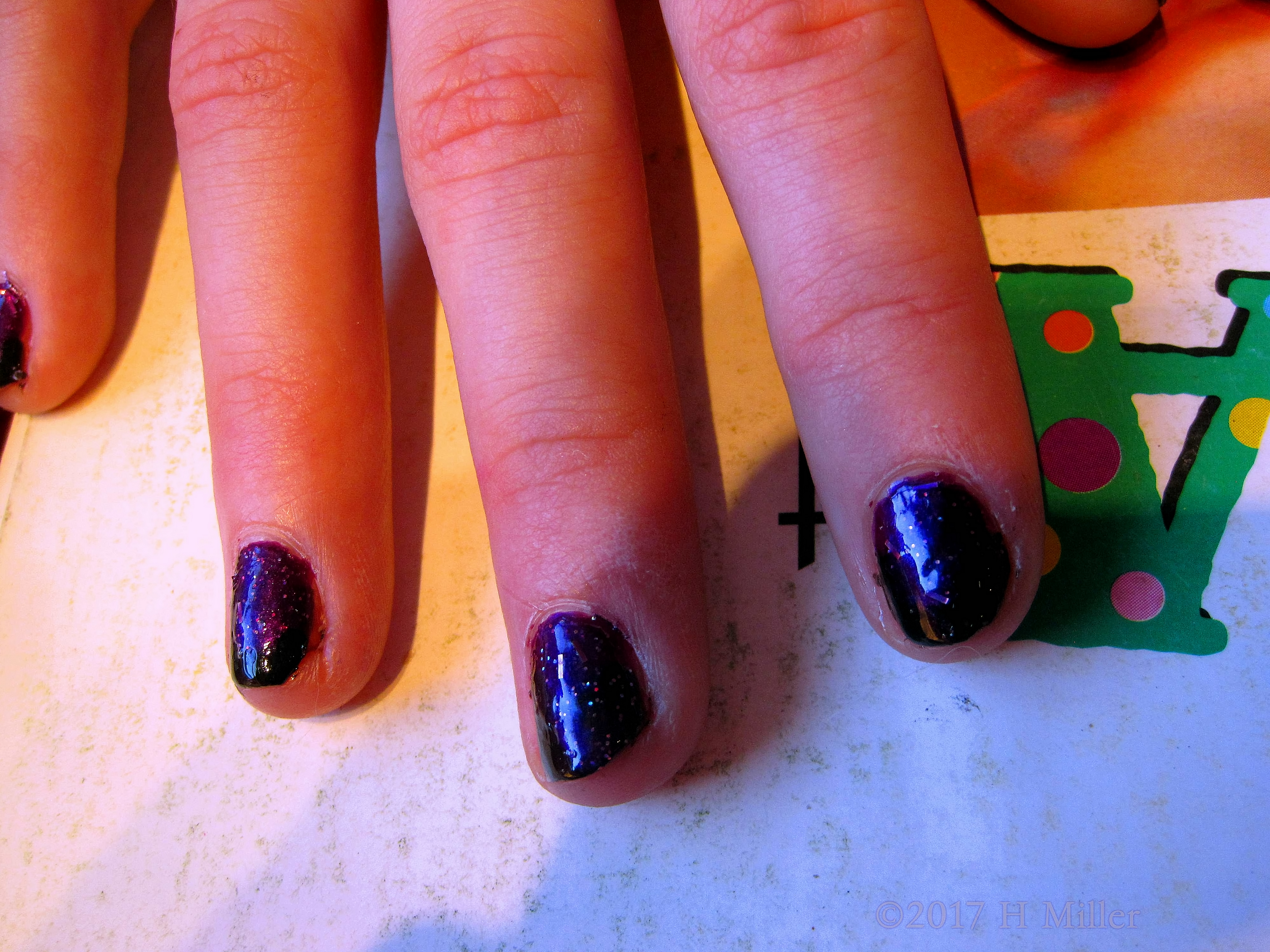 The Galaxy In Glitter Is This Girls Manicure.