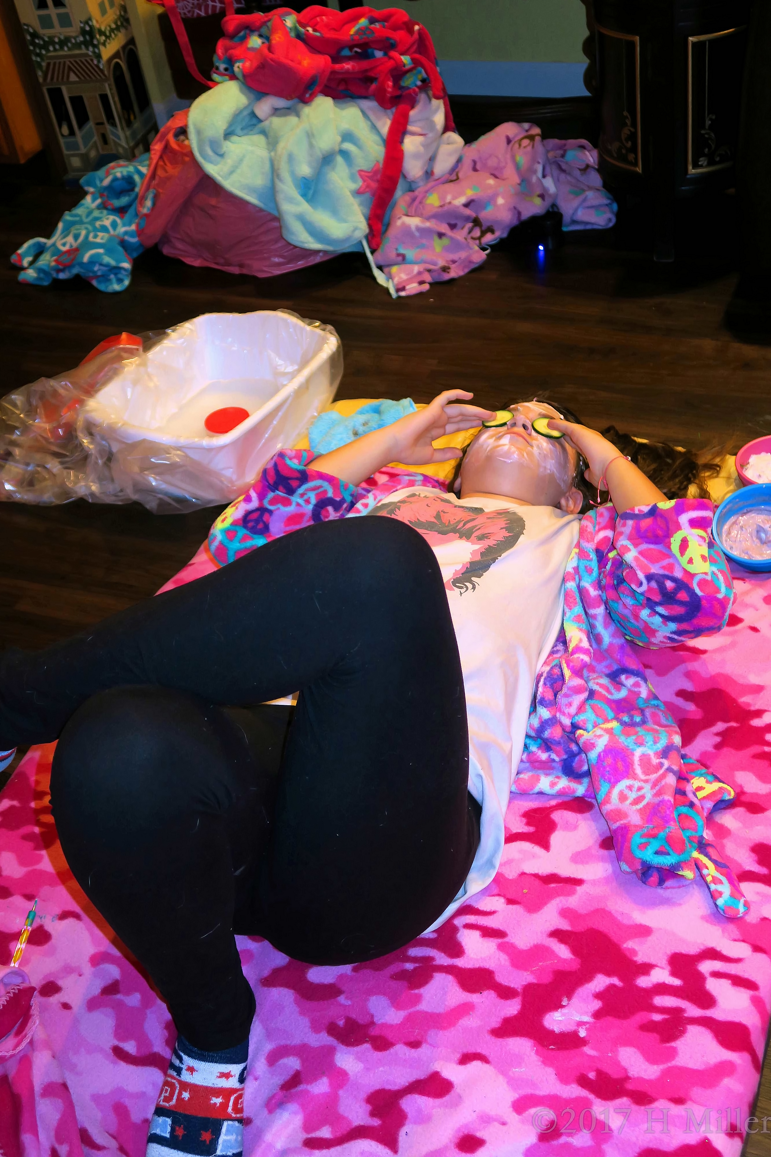 Adjusting The Cucumbers On Her Kids Facial. Adjusting The Cucumbers On Her Kids Facial.