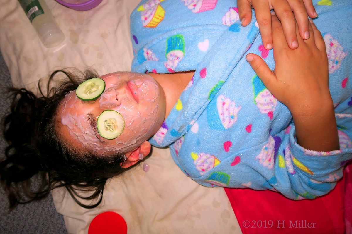 Chilling With Cukes On The Eyes During Kids Facials. 