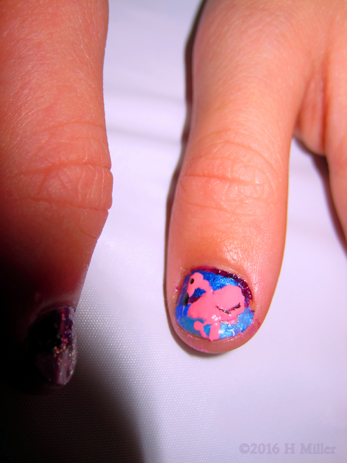 Close Up Of The Flamingo Nail Design On This Girls Mani.