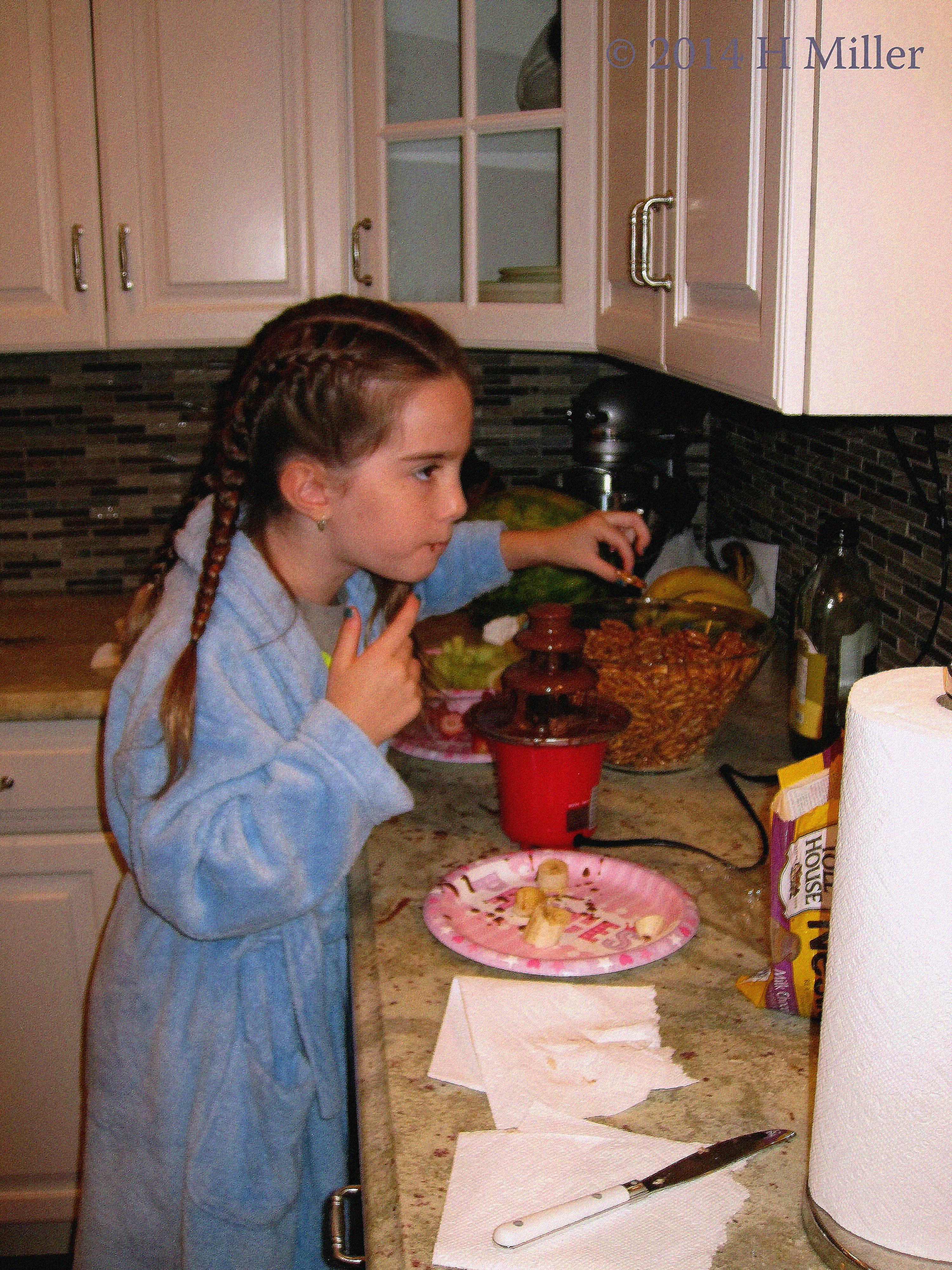 Enjoying Dipping Fruits In The Chocolate Fountain. Enjoying Dipping Fruits In The Chocolate Fountain.