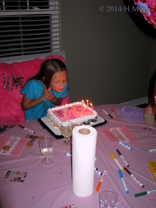 Caitlin Blowing Out The Candles At Her Spa Birthday Party.