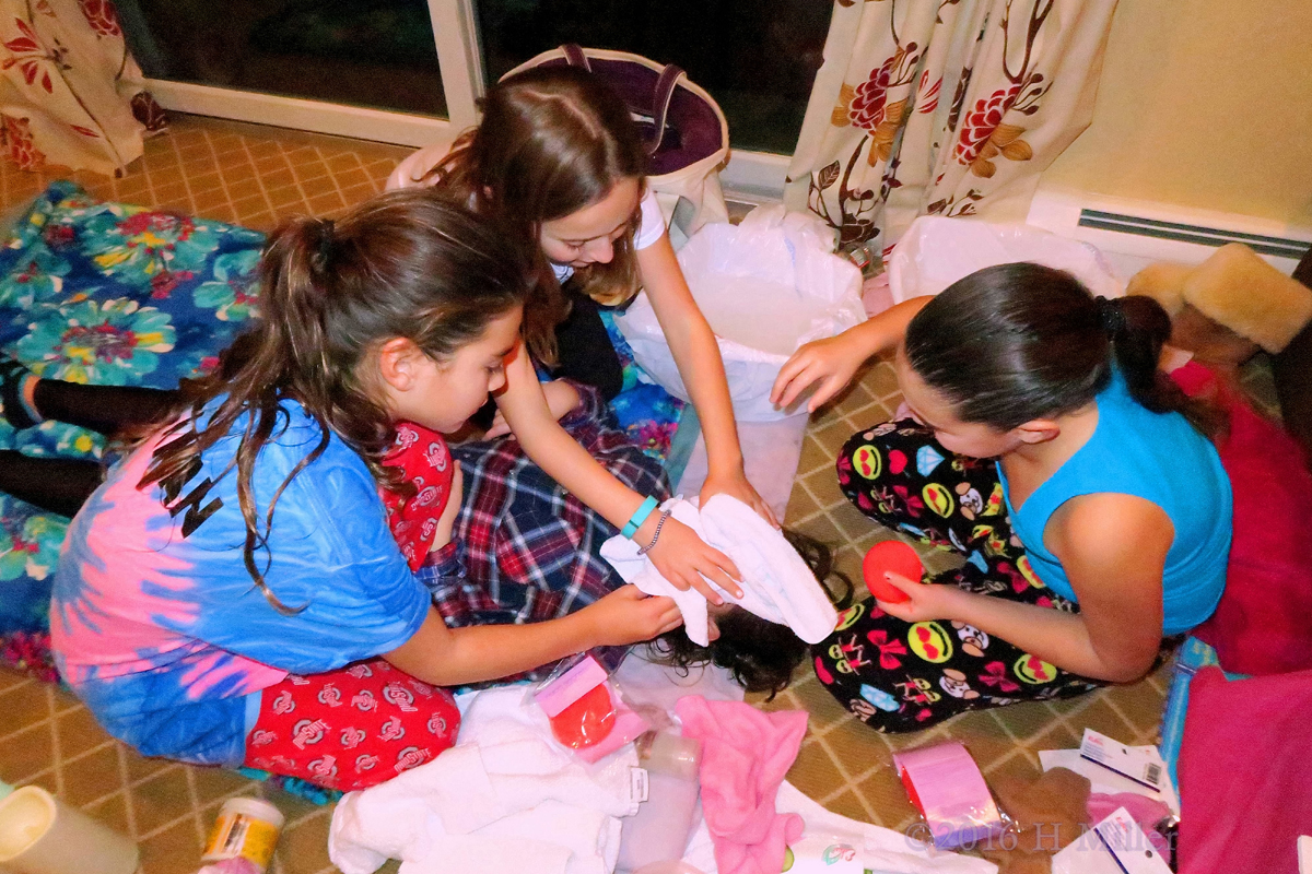 Girls Removing The Facial Mask For Their Friend. 