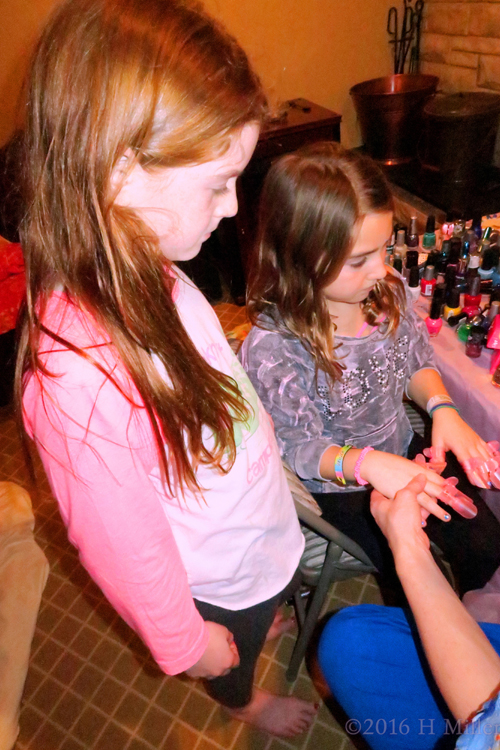 Watching As Nail Protectors Are Put On Freshly Painted Manis. Watching As Nail Protectors Are Put On Freshly Painted Manis.