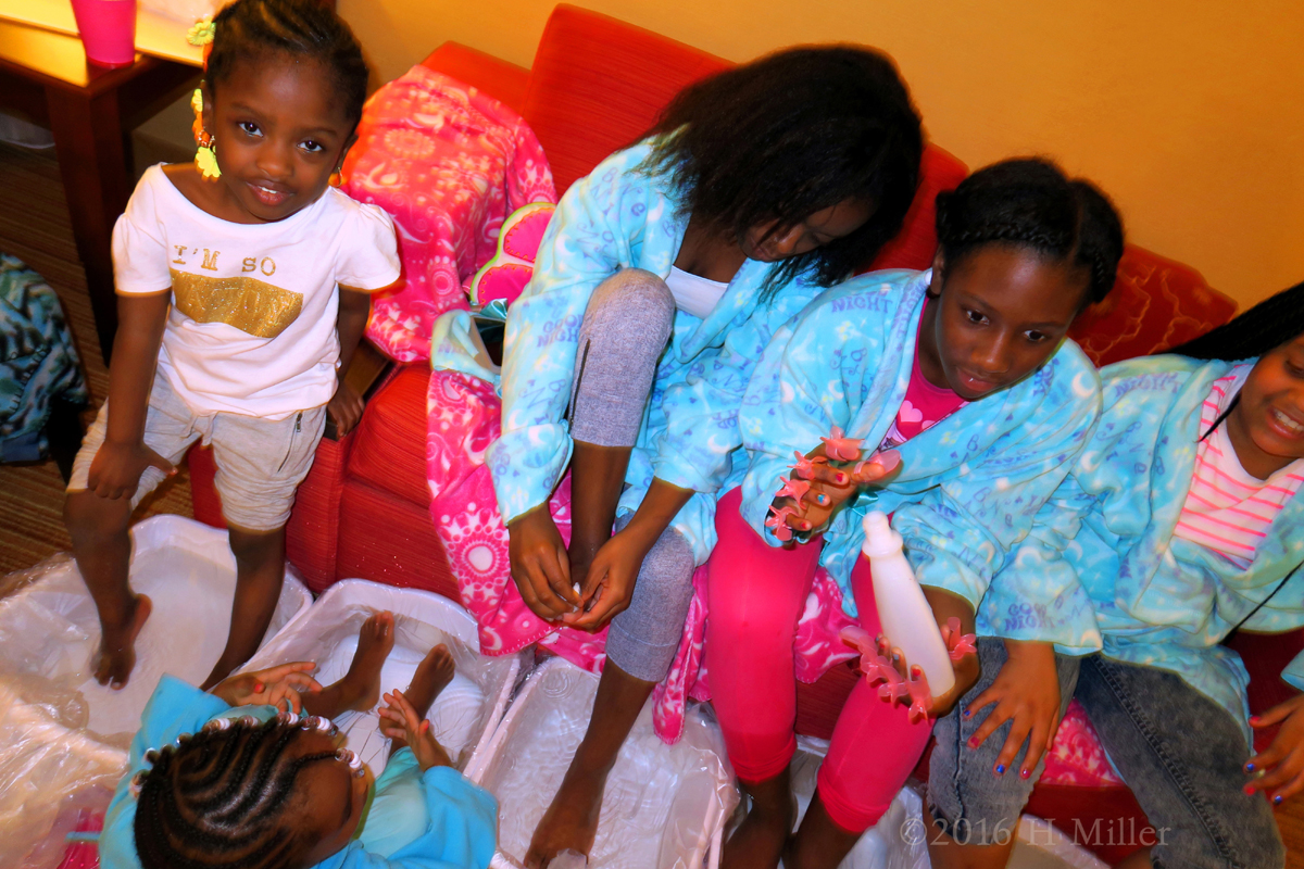 The Girls Participating In The Foot Soak Part Of The Mini Mani Activity. 