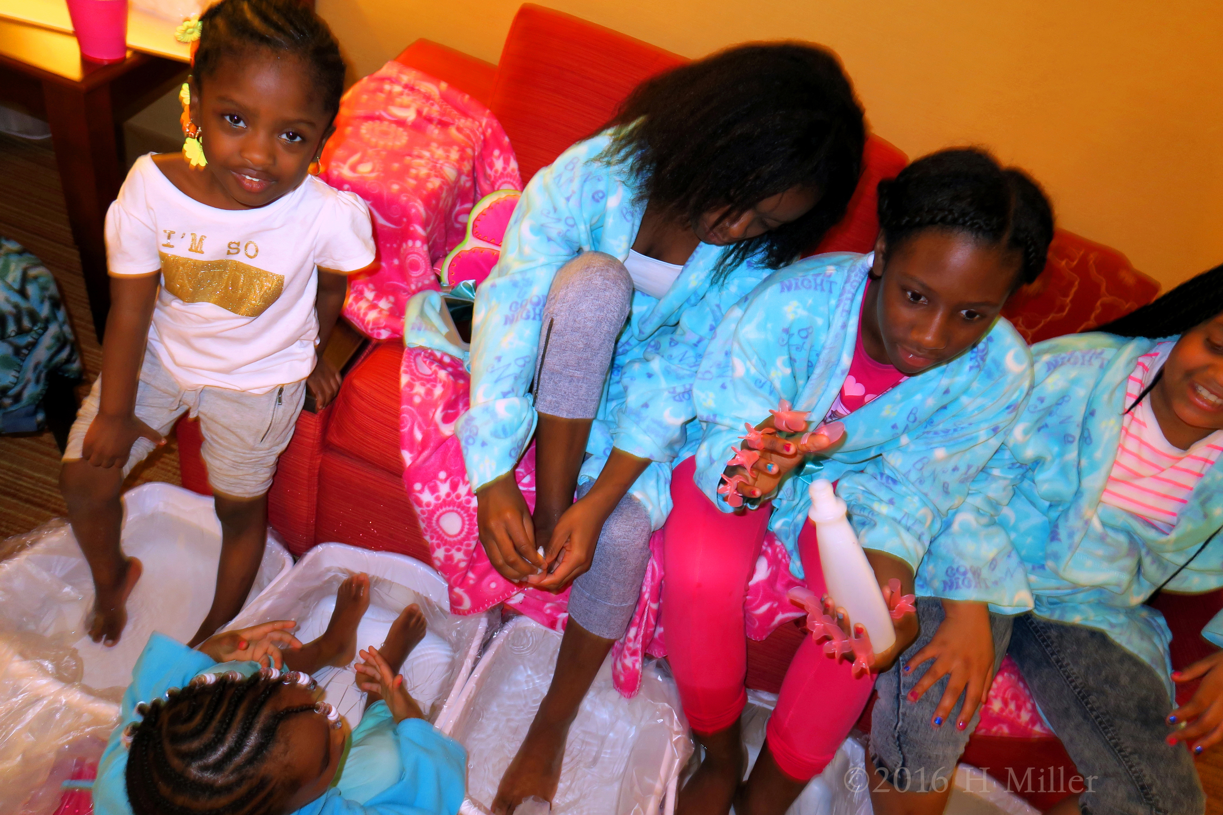 The Girls Participating In The Foot Soak Part Of The Mini Mani Activity. 