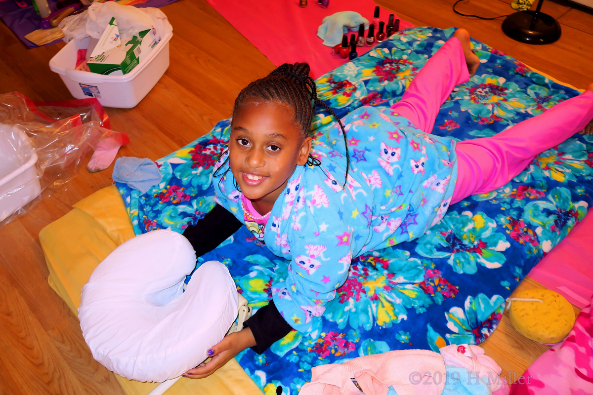 Guest With A Cat Robe During Her Kids Massage With A Relaxed Smile 