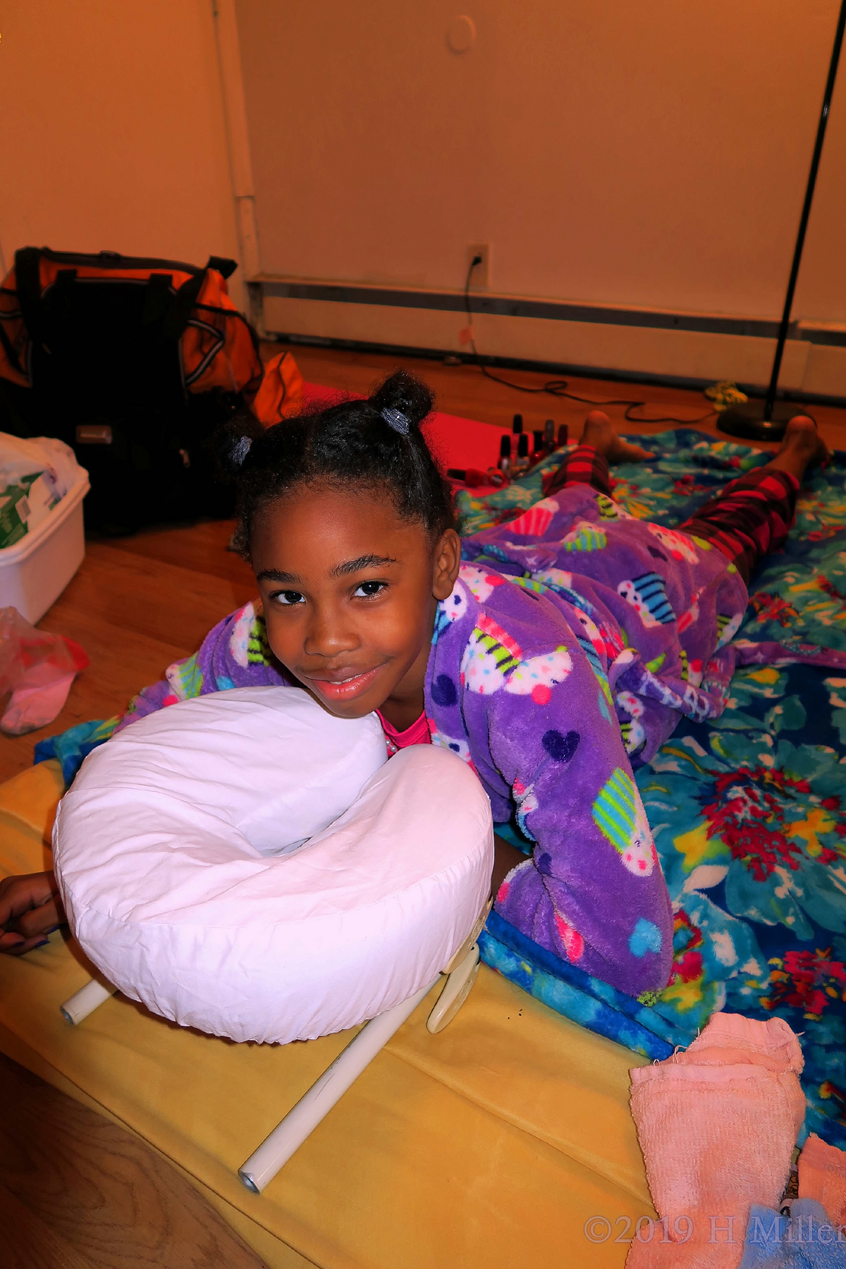 Guest With Cupcake Robe With A Happy Smile During Massage For Kids. 