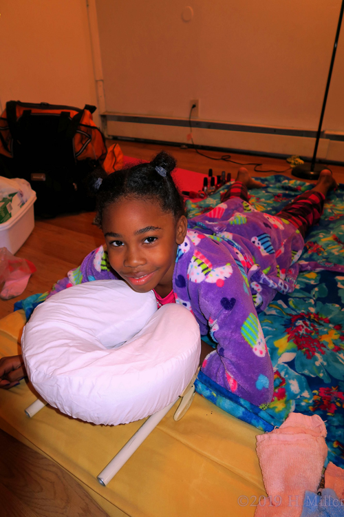 Guest With Cupcake Robe With A Happy Smile During Massage For Kids.