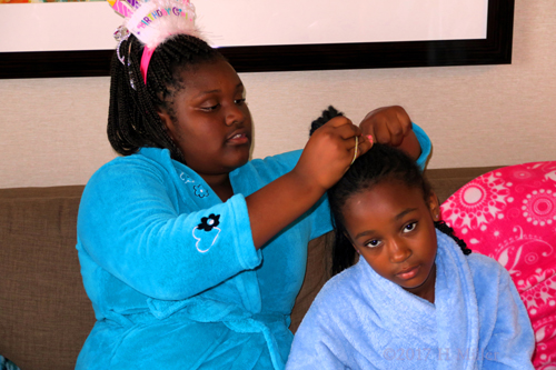 Birthday Girl Helps Tie The Hair Of Her Friend. Birthday Girl Helps Tie The Hair Of Her Friend.