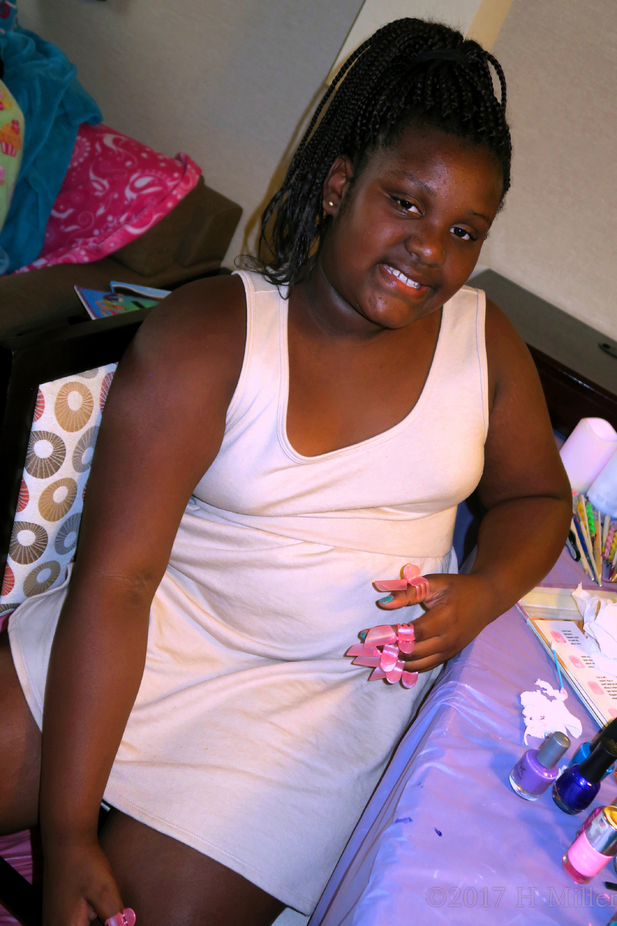 Cynaya Sitting At The Manicure Chair With Nail Protectors On Her Fingers. 