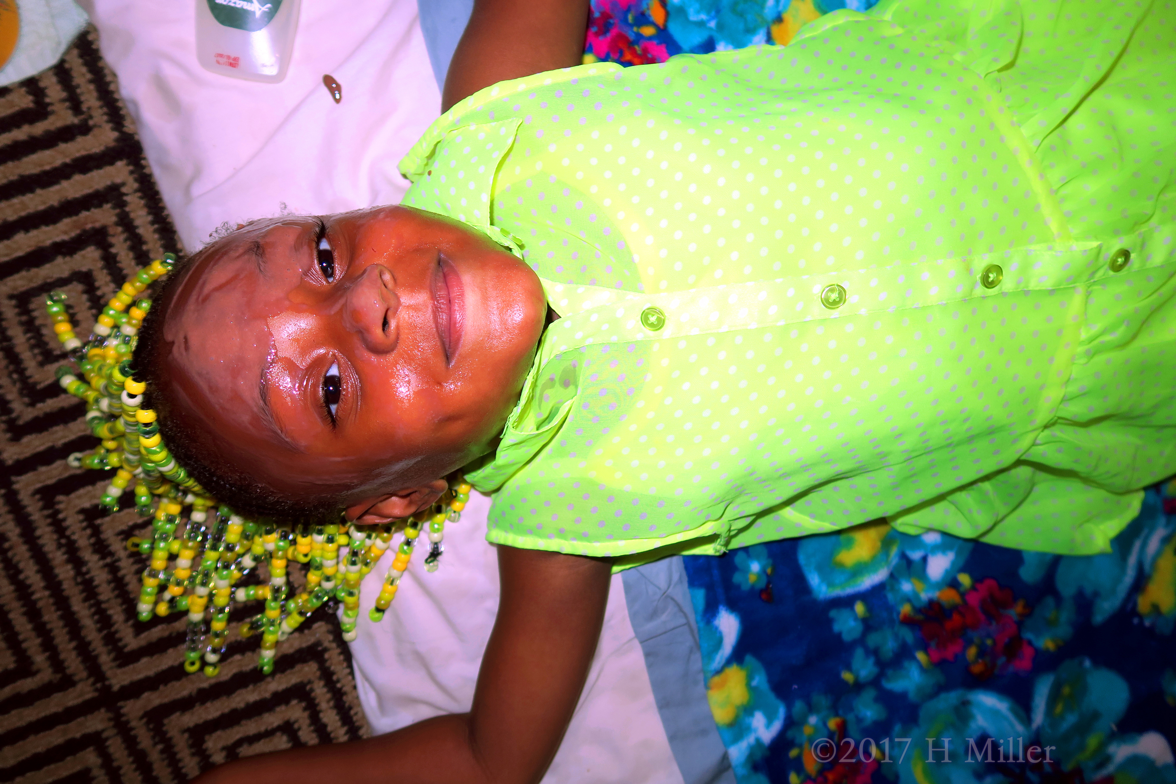 She's Happily Lying On The Kids Facial Mat With Masque On Her Face. She's Happily Lying On The Kids Facial Mat With Masque On Her Face.