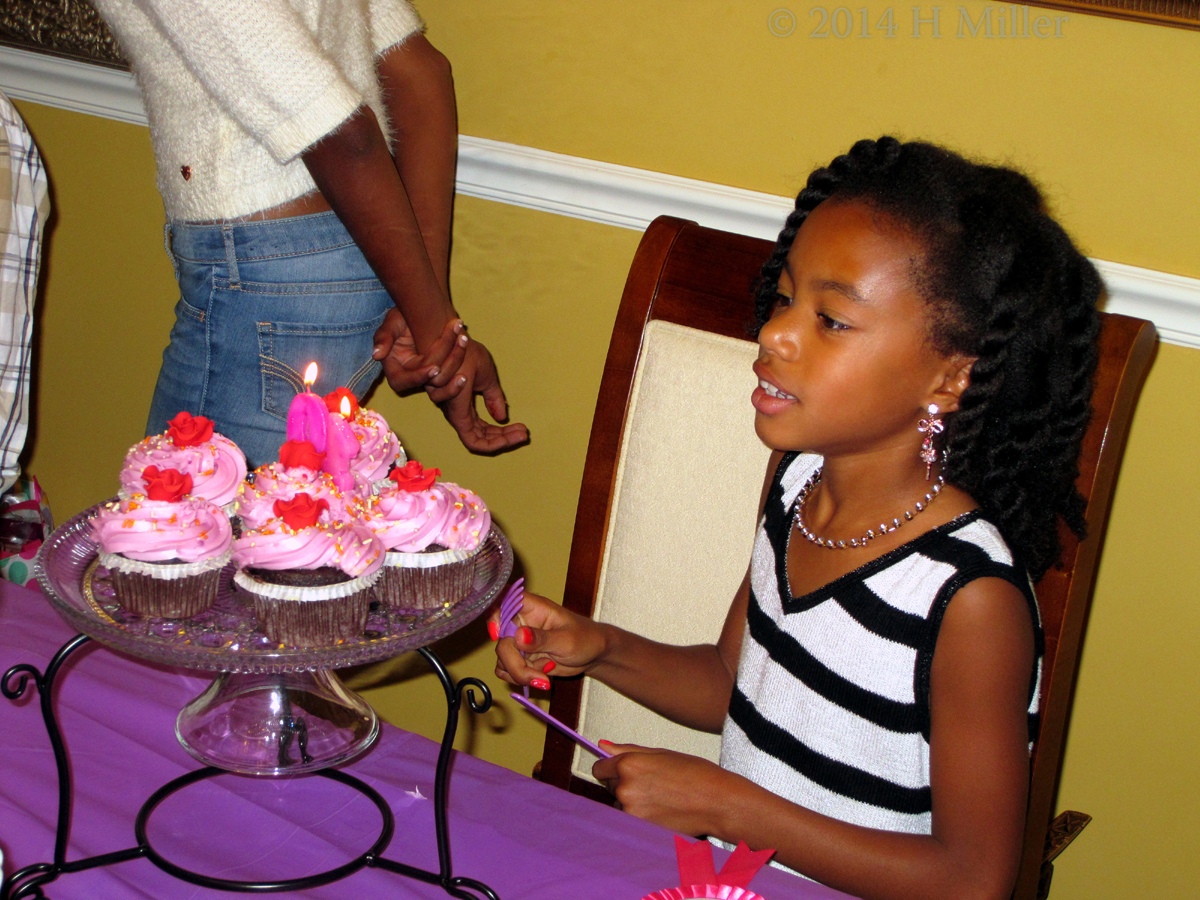 The Birthday Girl Admiring The Cupcakes. 