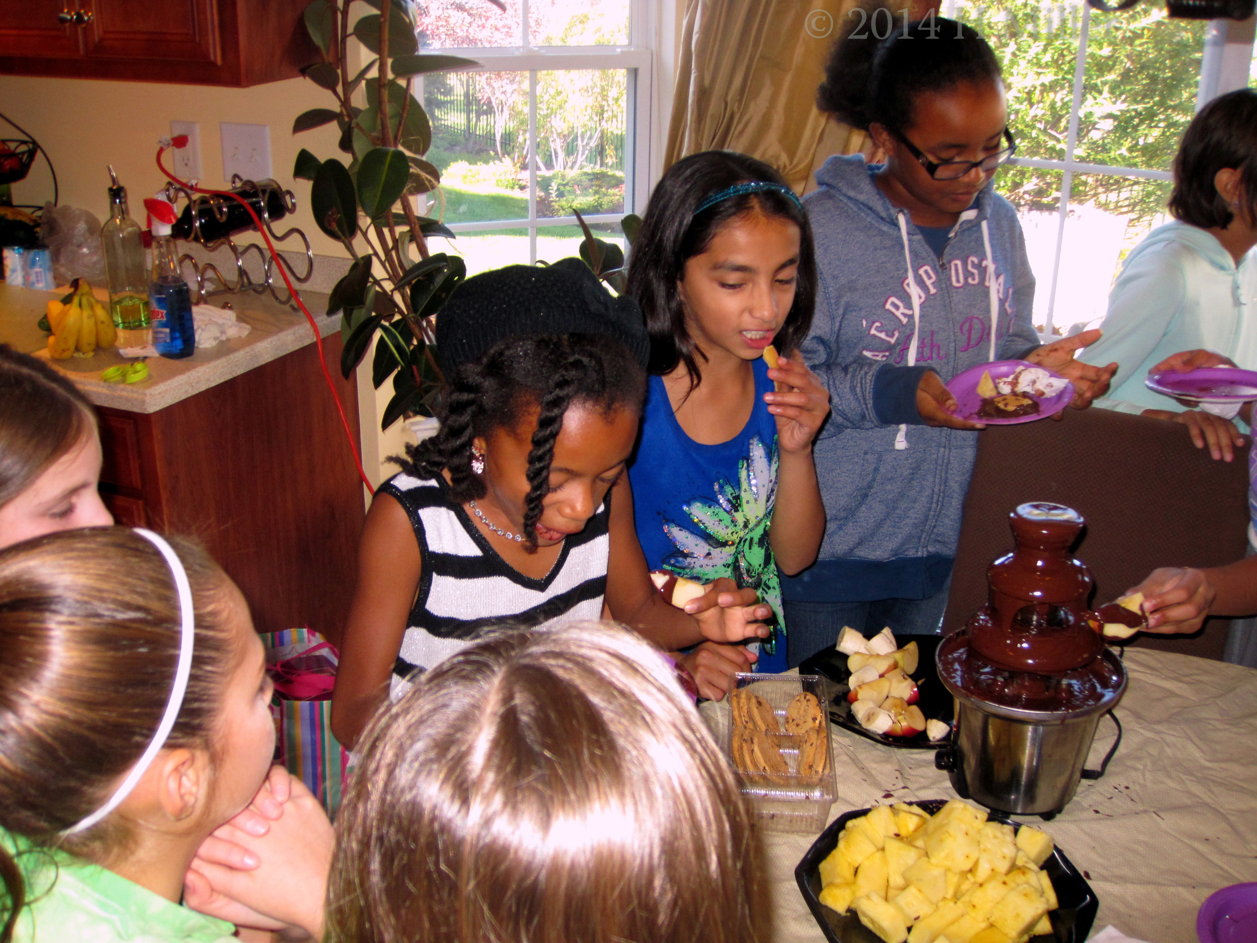 The Girls Enjoying Fruit And Cookies Dipped In Melted Chocolate! Yum! The Girls Enjoying Fruit And Cookies Dipped In Melted Chocolate! Yum!