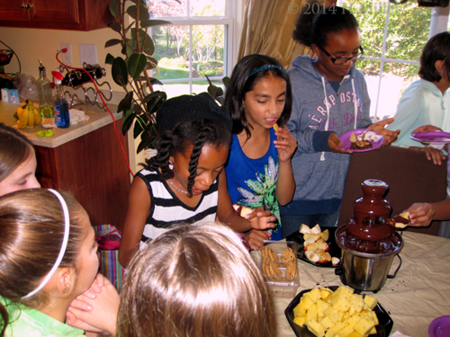 The Girls Enjoying Fruit And Cookies Dipped In Melted Chocolate! Yum
