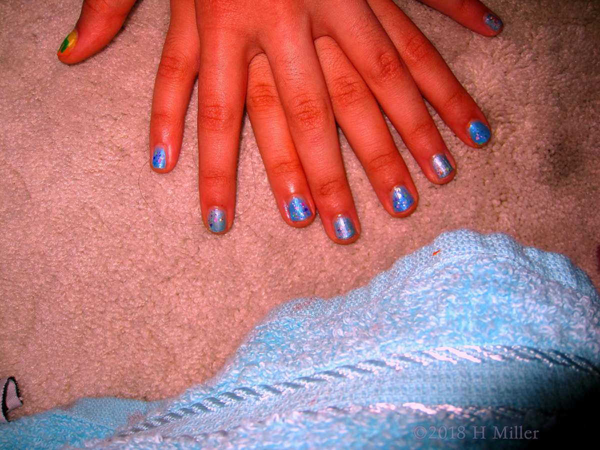 Shiny Blue Nail Polish With Colorful Glitter On Top For A Lovely Girls Manicure! 