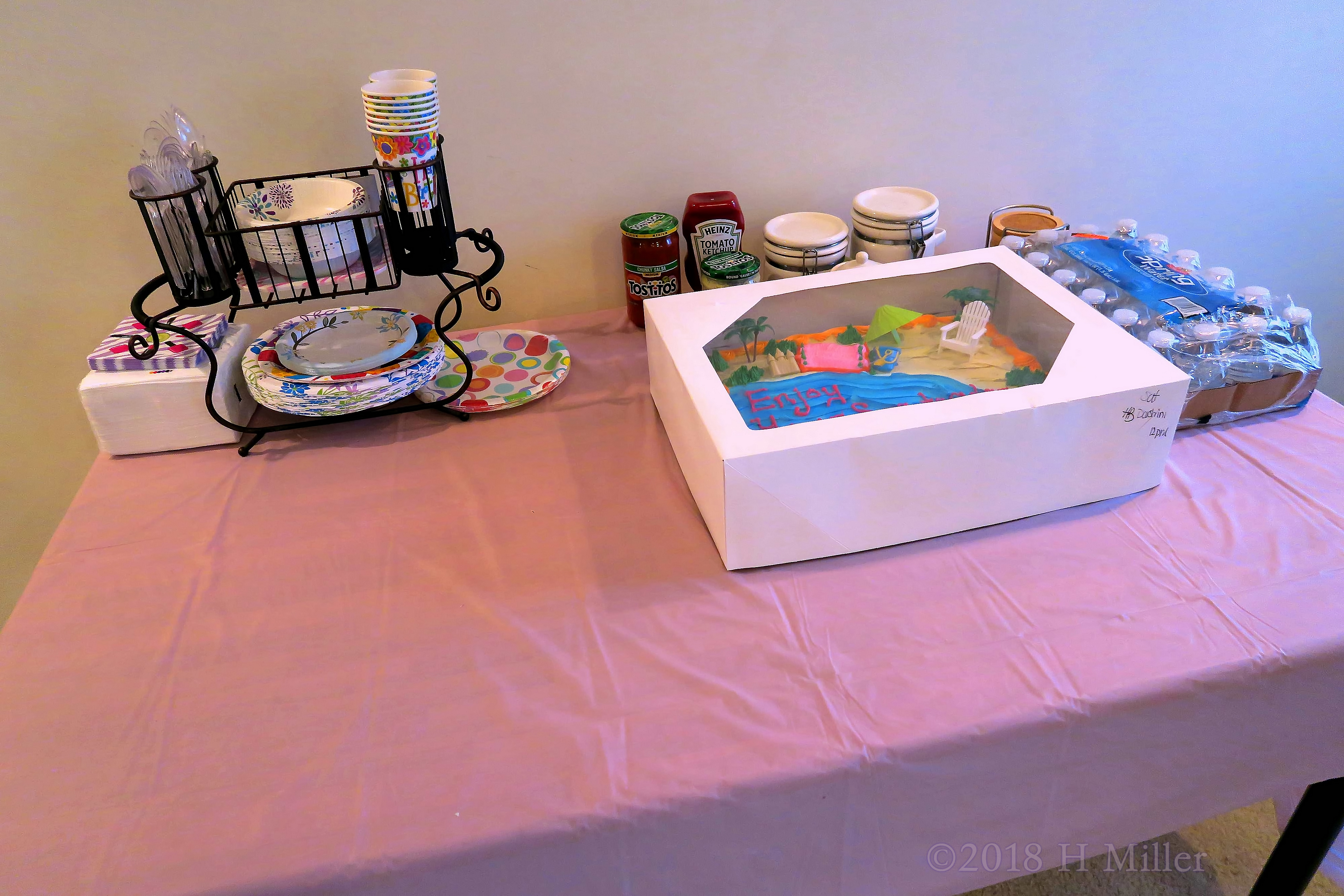 Neatly Arranged Glasses And Plates With The Super Cool Beach Birthday Cake! 