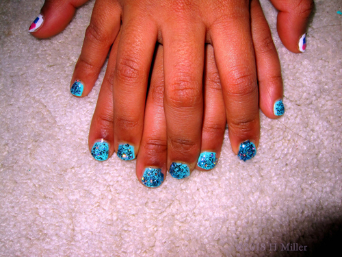 Showing Her Utterly Glittery Marbled Design Nail Art For Kids.