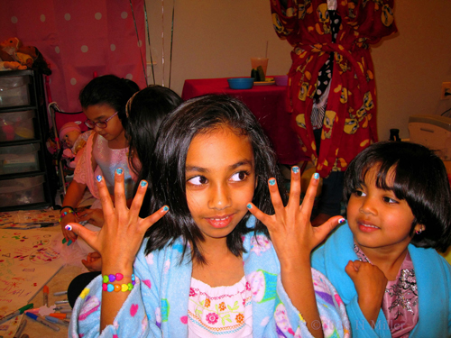 The Girl Happily Shows Her Shiny Cupcake Nail Art.