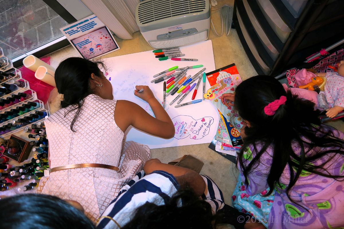The Girls Are Busy Drawing On The Spa Birthday Card With Colorful Markers And Stickers! 