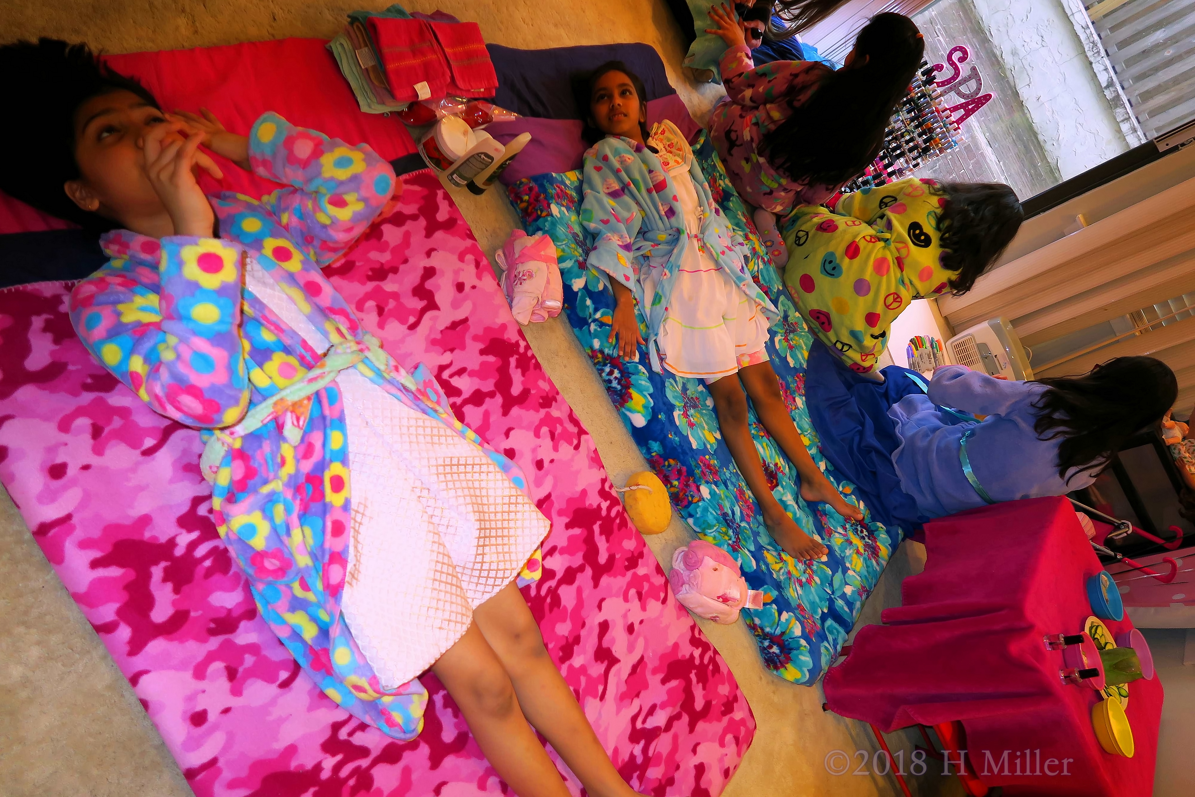 A Joyful View Of The Spa Party Where The Girls Are Enjoying Facials And Manicures!