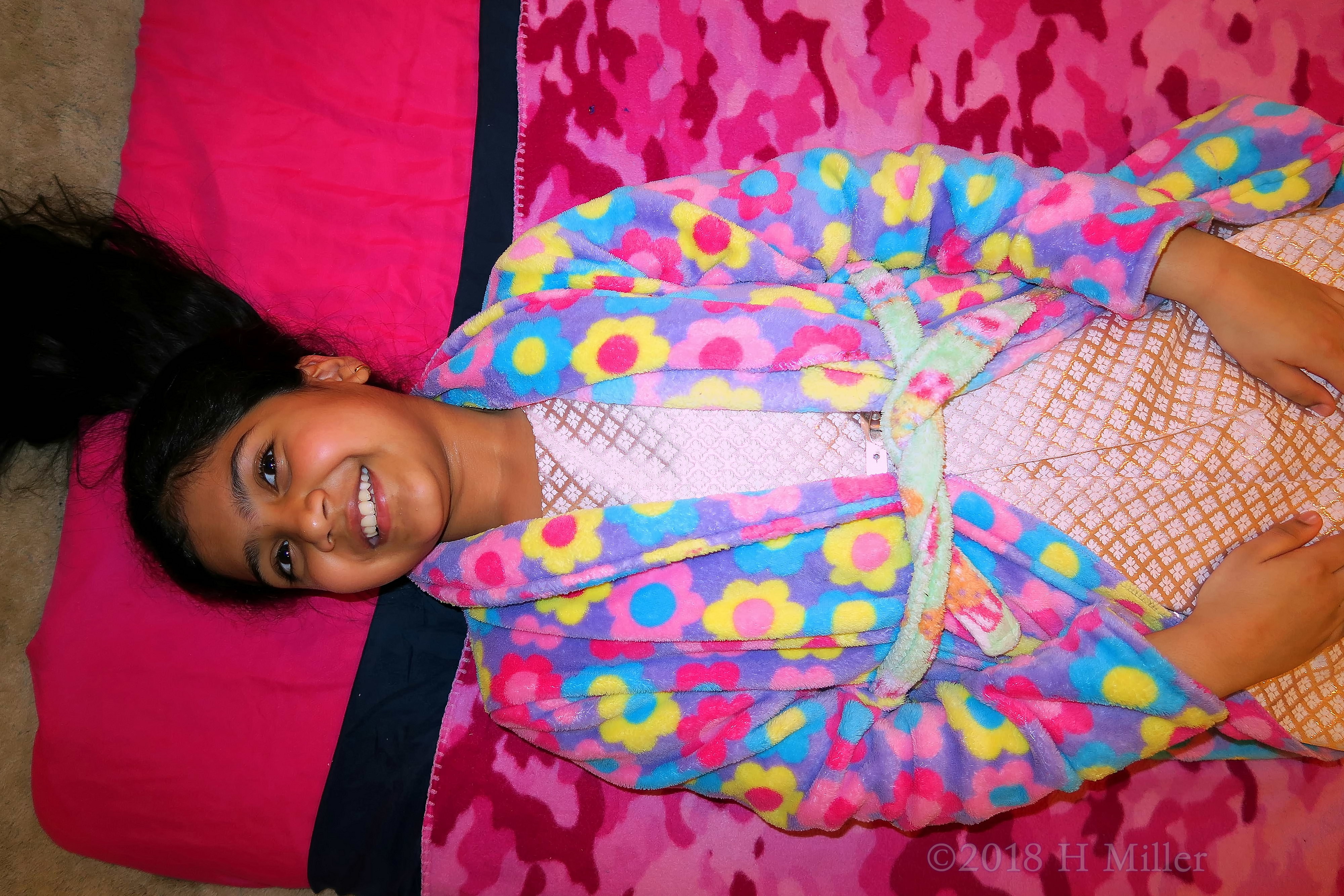 Joyful Birthday Girl Lying On The Kids Facial Mat, Ready To Begin! Joyful Birthday Girl Lying On The Kids Facial Mat, Ready To Begin!