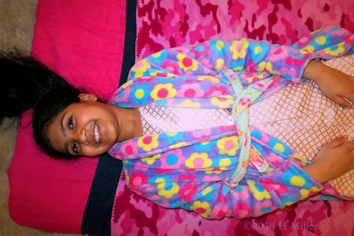 Joyful Birthday Girl Lying On The Kids Facial Mat, Ready To Begin Joyful Birthday Girl Lying On The Kids Facial Mat, Ready To Begin