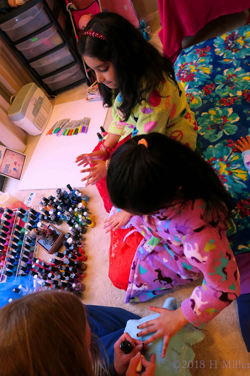 Putting On Shiny Black Nail Polish During Kids Manicures