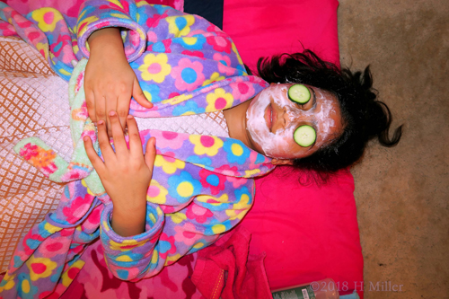 Relaxing On The Kids Facial Mat, With Masque And Cukes On Her Eyes. Relaxing On The Kids Facial Mat, With Masque And Cukes On Her Eyes.