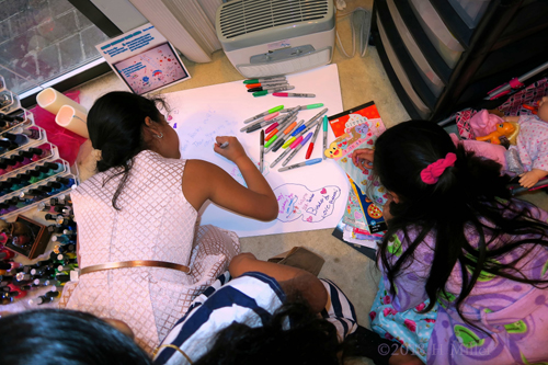 The Girls Are Busy Drawing On The Spa Birthday Card With Colorful Markers And Stickers!