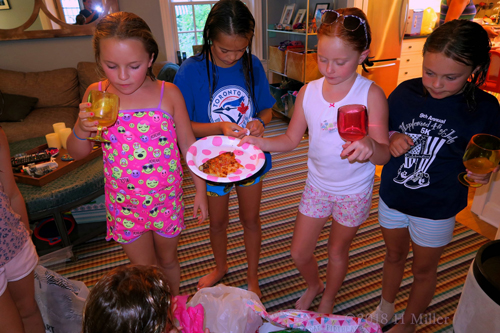 The Girls Are Enjoying A Slice Of Pizza With Refreshing Drinks!