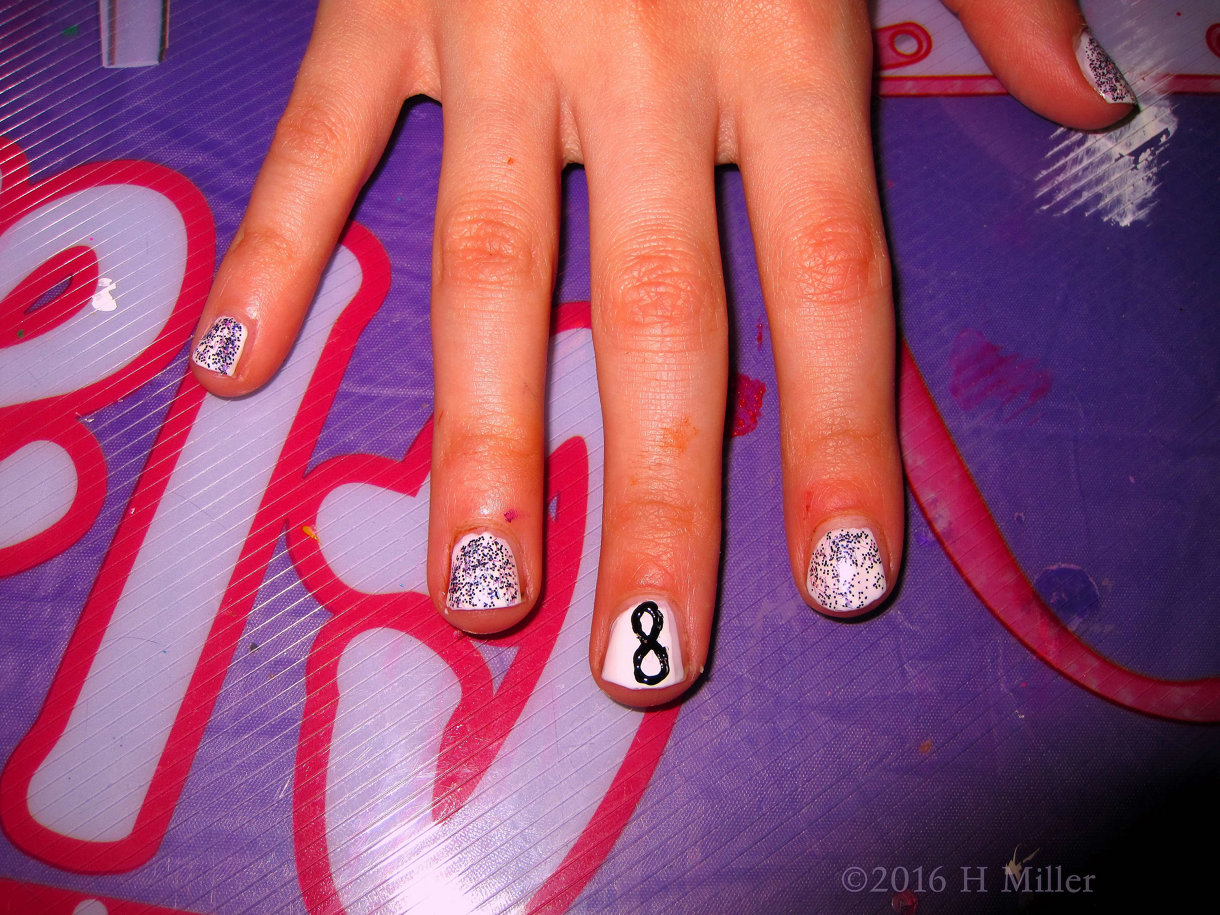 She Has A Super Cute Glitter And Infinity Manicure. She Has A Super Cute Glitter And Infinity Manicure.