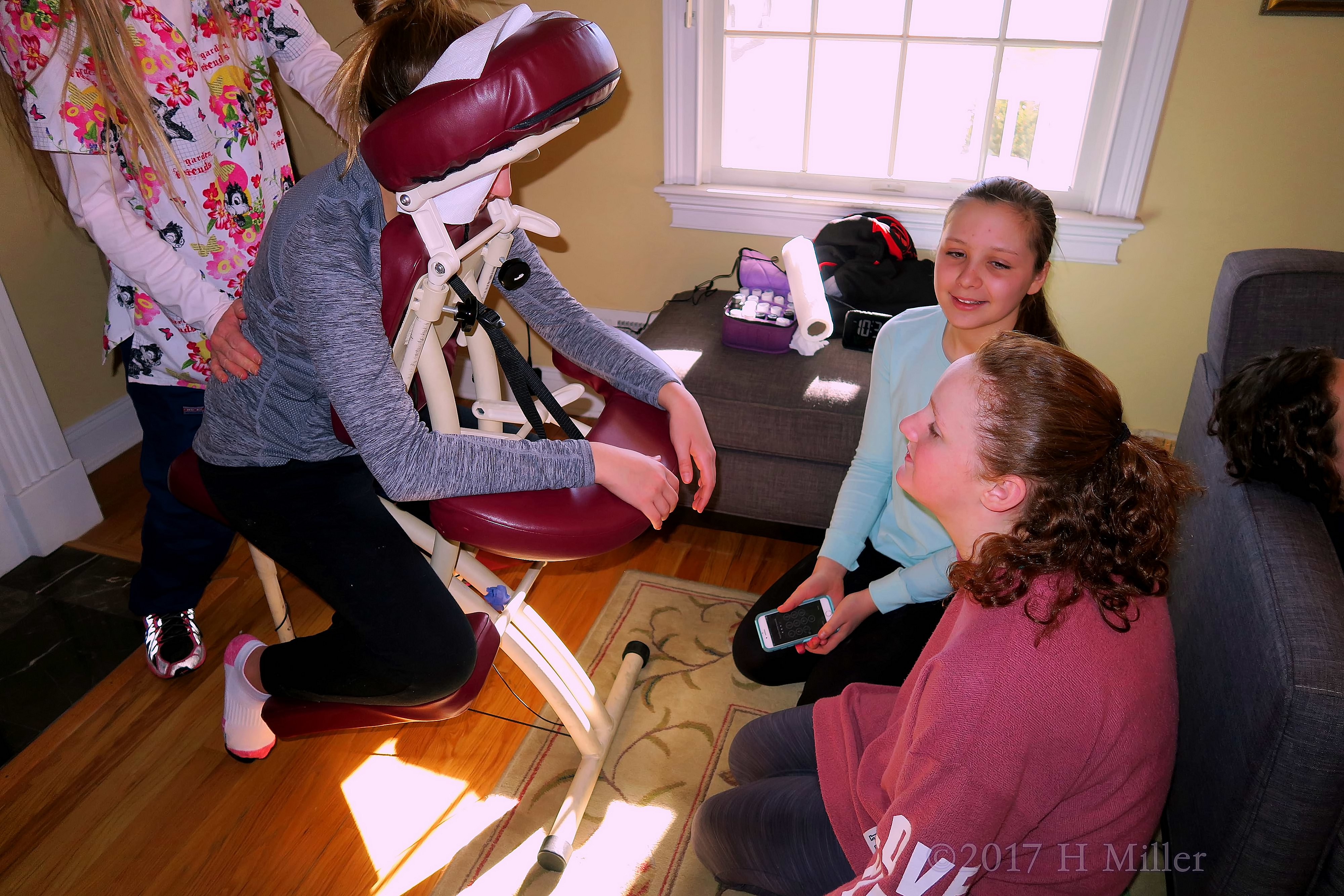 Massages And Moral Support. Party Guests Chatting During Chair Massage Massages And Moral Support. Party Guests Chatting During Chair Massage