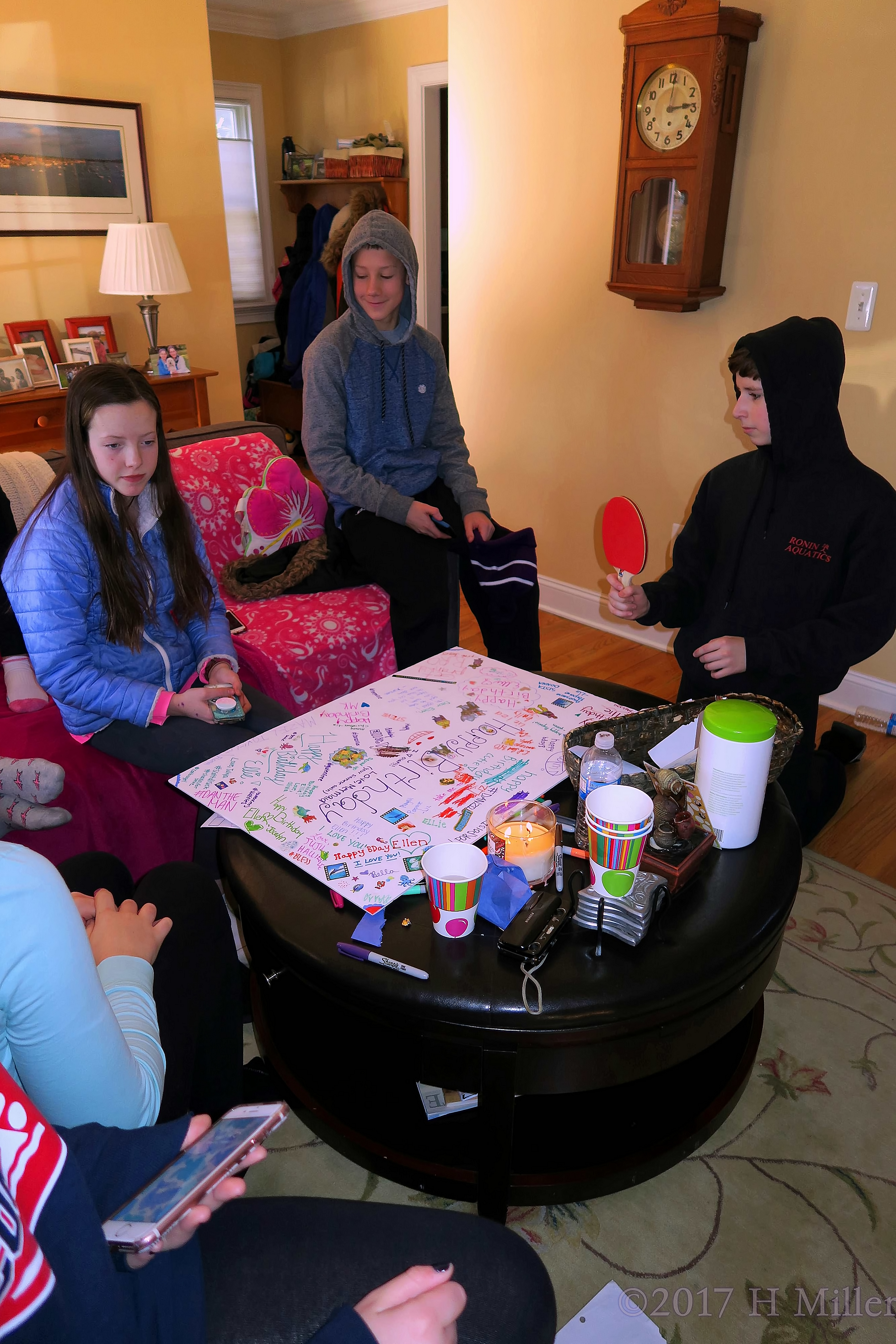 Paddles, Phones, And Party Guests Signing The Spa Birthday Card 