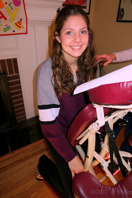 Party Guest Smiling Before Her Relaxing Chair Massag