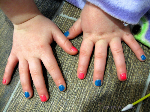 Kids Manicure Glossy Blue And Pink Polish On Every Other Nail Looks Super Cool