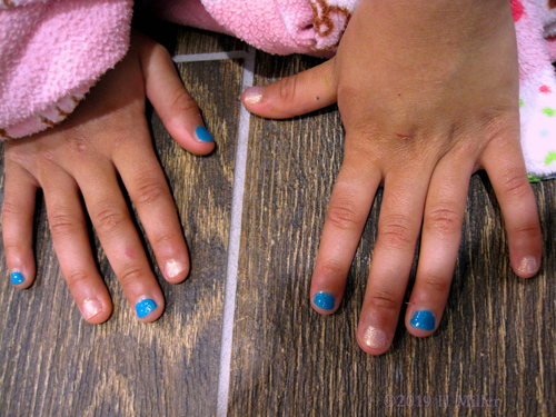 Kids Manicure Has Light Pink Glitter Polish With Blue Glossy Polish On Alternating Finger