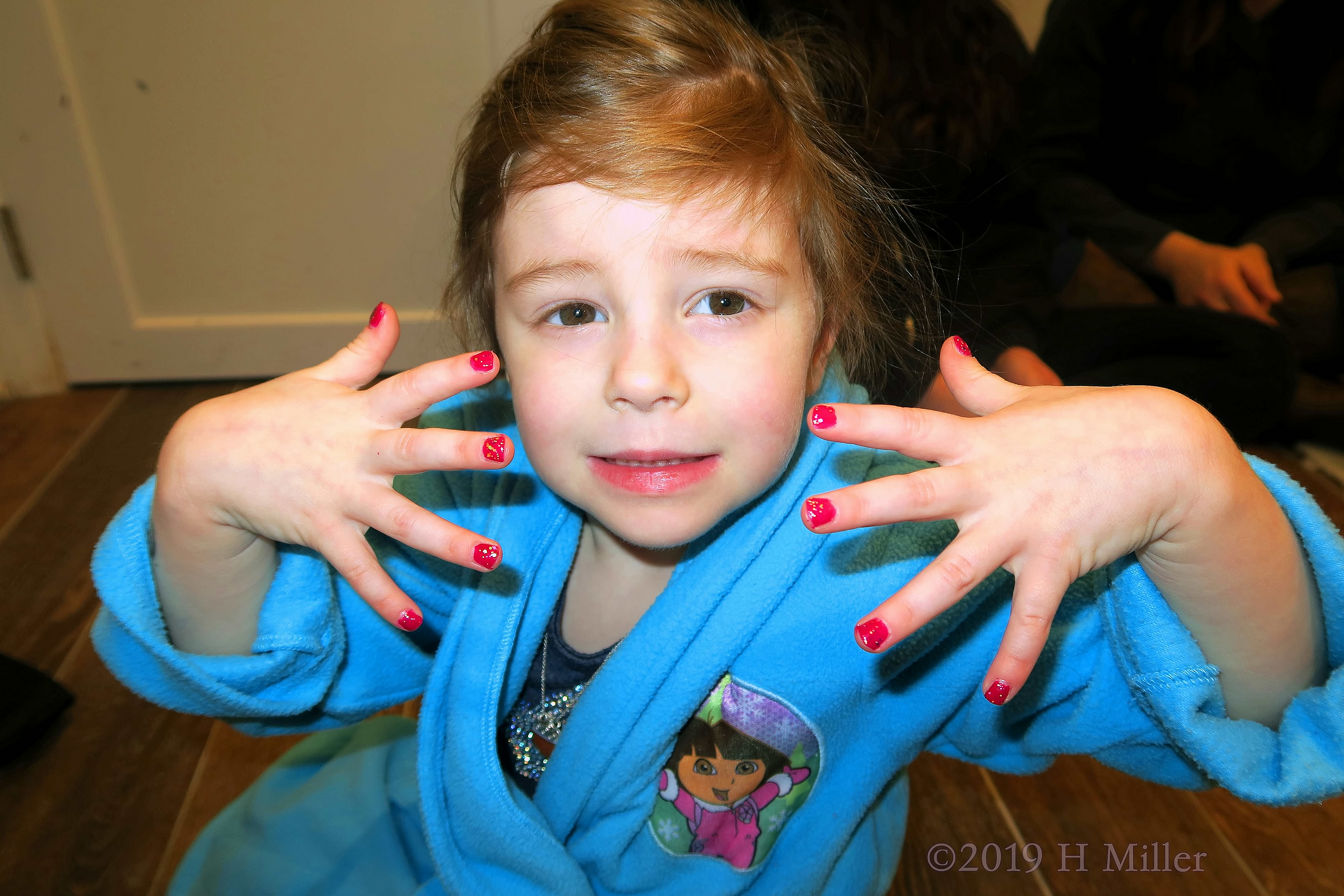 Spa Party Guest In Dora Kids Spa Robe Showing Her Girls Mini Mani!
