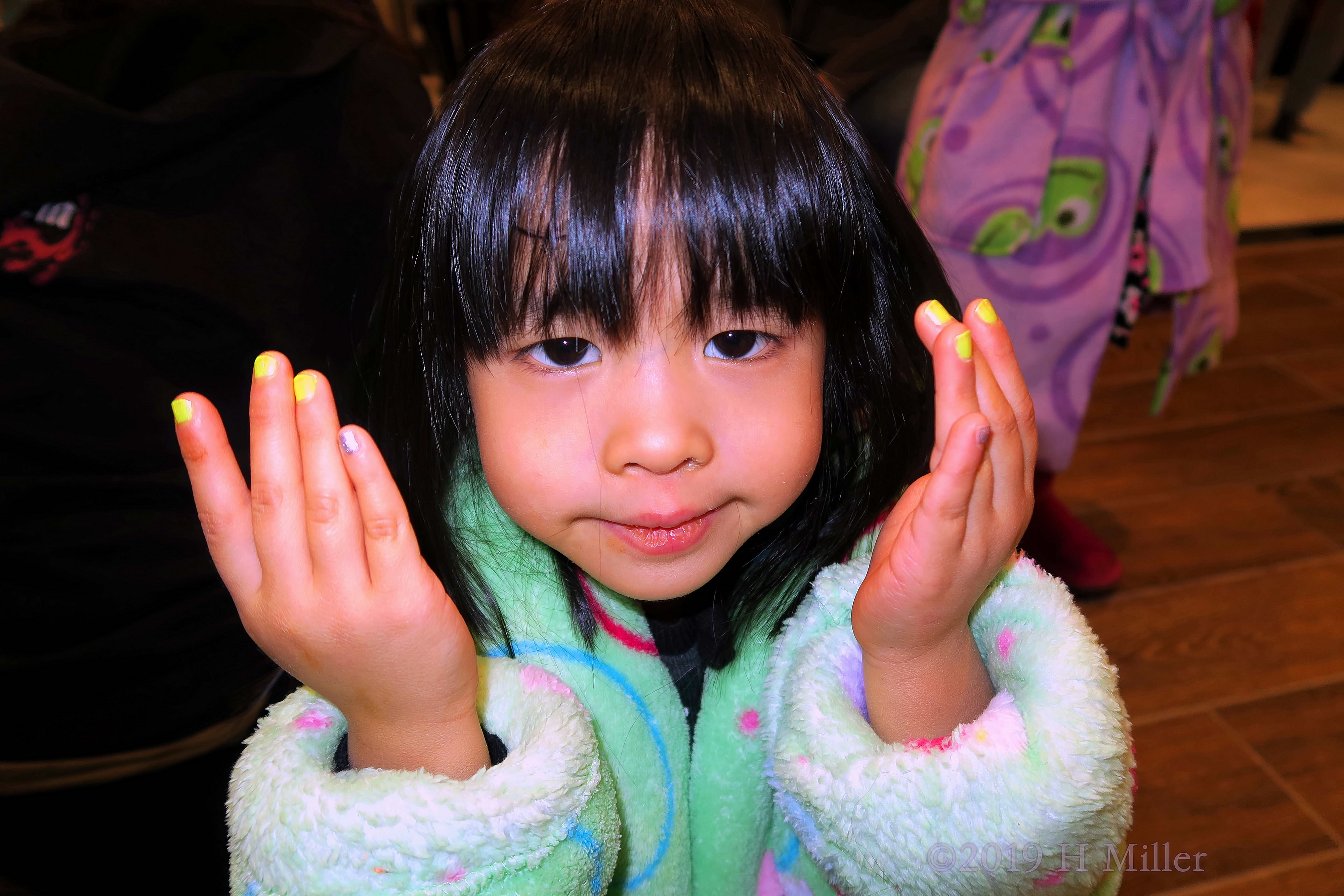 Spa Party Guest Modeling Her Colorful Girls Manicure