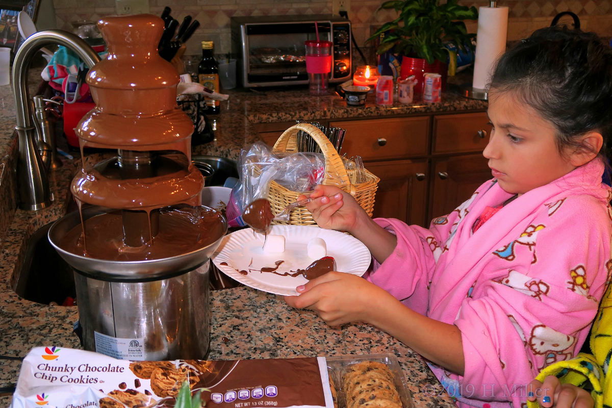 Party Guest Carefully Gets Chocolate From Chocolate Fountain!