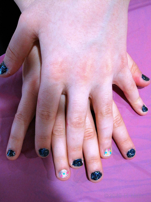 Pretty Sparkly Blue And White Girls Manicure With Rainbow Glitter. Pretty Sparkly Blue And White Girls Manicure With Rainbow Glitter.