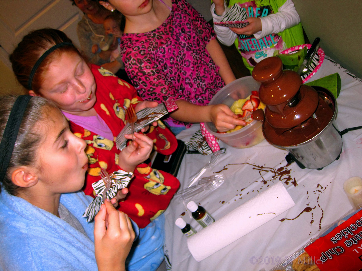 Fruits And Forks In The Fountain Of Chocolate! Party Guests Try The Chocolate Fountain!